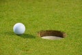 Golf ball on lip of cup Royalty Free Stock Photo