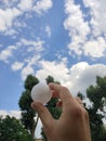 Golf ball in a man`s hand in nature Royalty Free Stock Photo