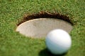 Golf ball near hole Royalty Free Stock Photo