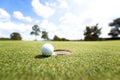 Golf ball near hole, Royalty Free Stock Photo