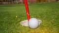 Golf ball near hole with flag Royalty Free Stock Photo