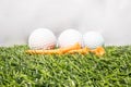 The golf ball is placed on a green artificial grass. It means getting ready to play golf Royalty Free Stock Photo