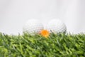 The golf ball is placed on a green artificial grass. It means getting ready to play golf Royalty Free Stock Photo