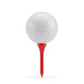 A golf ball positioned on top of a red tee marker against a plain background Royalty Free Stock Photo