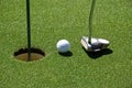 Golf ball on practice hole Royalty Free Stock Photo