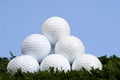 Golf Ball Pyramid on grass against blue sky Royalty Free Stock Photo