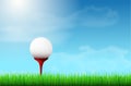 Golf ball on red tee, grass and blue sky Royalty Free Stock Photo