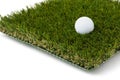 Golf Ball Resting on Section of Artificial Turf Grass On White Background Royalty Free Stock Photo