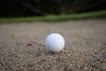 Golf ball on the sand in beautiful golf course at sunset backgro Royalty Free Stock Photo
