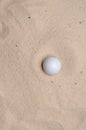 golf ball in a sand trap
