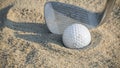 Golf Ball in Sand Trap with Pitching Wedge Royalty Free Stock Photo