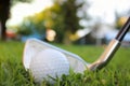 Golf ball set on a tee in the grass and hit with an Iron Set golf club Royalty Free Stock Photo