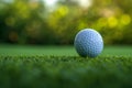 A golf ball sits prominently on top of a perfectly maintained, vibrant green field, Close-up of a golf ball on a tee, AI Generated