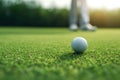 A golf ball sitting next to a hole on a perfect golf green. Generative AI Royalty Free Stock Photo