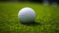 a golf ball sitting on the smooth, short-cropped grass of a putting green. The ball's texture and the precision of Royalty Free Stock Photo