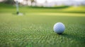 Golf ball on sun-lit green field near hole dew on grass. Unscored goal. One step away from victory. Royalty Free Stock Photo