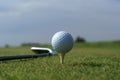 Golf ball in tall green grass against blue sky Royalty Free Stock Photo