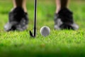 Golf ball on tee in beautiful grass in golf course for shot to hole in one in competition with iron 7 Royalty Free Stock Photo