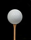 Golf ball on tee on black Royalty Free Stock Photo