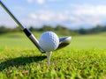Golf ball on tee with golf club on golf course Royalty Free Stock Photo