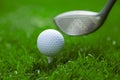 Golf Ball on Tee and Club on Golf Course Royalty Free Stock Photo