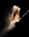 Golf ball tee explode from sand bunker. Golfer hit ball with club to sand explosion to green. Golf club hit ball tee in sand wedge Royalty Free Stock Photo