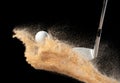 Golf ball tee explode from sand bunker. Golfer hit ball with club to sand explosion to green. Golf club hit ball tee in sand wedge Royalty Free Stock Photo