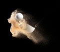 Golf ball tee explode from sand bunker. Golfer hit ball with club to sand explosion to green. Golf club hit ball tee in sand wedge Royalty Free Stock Photo