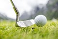 Golf ball on tee in front of driver Royalty Free Stock Photo