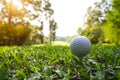 Golf ball is on tee at green lawn in a beautiful golf course with morning sunshine.Ready for golf in the first short Royalty Free Stock Photo