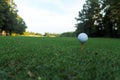 Golf ball on tee at a low perspective