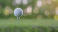Golf ball on tee in lush grass field with a soft-focus, bokeh green background Royalty Free Stock Photo