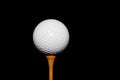Golf Ball on Tee-Peg on black background Royalty Free Stock Photo