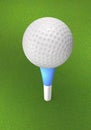 Golf ball on the tee peg on the grass. Royalty Free Stock Photo
