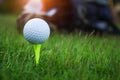 Golf ball on tee ready to be shot. golf ball on tee in the evening golf course with sunshine Royalty Free Stock Photo