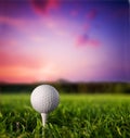 Golf ball on tee at sunset Royalty Free Stock Photo