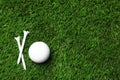 Golf ball and tees on artificial grass, space for text Royalty Free Stock Photo