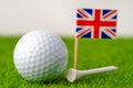 Golf ball with United kingdom flag on green lawn or field Royalty Free Stock Photo