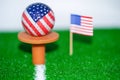 Golf ball with USA flag on green lawn or field Royalty Free Stock Photo