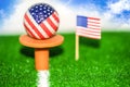 Golf ball with USA flag on green lawn or field. Royalty Free Stock Photo