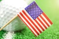 Golf ball with USA flag on green lawn or field. Royalty Free Stock Photo