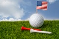 Golf ball with USA flag and tee on green grass, most popular sport in the world Royalty Free Stock Photo