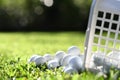 Golf balls in basket on green grass for practice