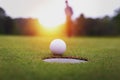 Golf balls and golf club on green grass shiny light sunse Royalty Free Stock Photo