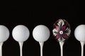 Golf balls and egg on a black glass desk Royalty Free Stock Photo
