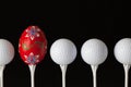 Golf balls and egg on a black glass desk Royalty Free Stock Photo