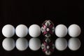 Golf balls and egg on a black glass table Royalty Free Stock Photo