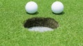 Golf balls near the hole close up Royalty Free Stock Photo