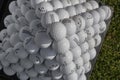 Golf balls pyramid on driving range Royalty Free Stock Photo