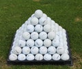 Golf balls pyramid on driving range Royalty Free Stock Photo